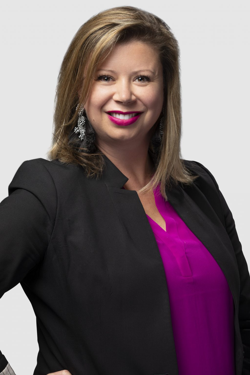 Professional headshot of Leah Maki, smiling and facing the camera against a neutral background.